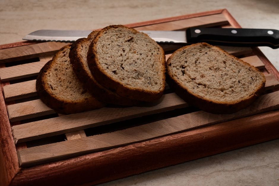 Best Bread Maker Machines 2026: Zojirushi vs Cuisinart vs Freshly baked homemade bread sliced on a wooden cutting board