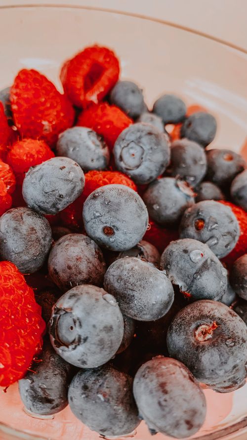 Free Close-up of fresh blueberries and raspberries in a bowl, showcasing vibrant colors and textures. Stock Photo