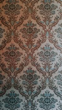 Intricate vintage floral pattern on wallpaper adds classic charm to any space.