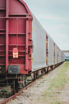 A lengthy freight train captured at a railyard in Arles, Provence, showcasing industrial transport.