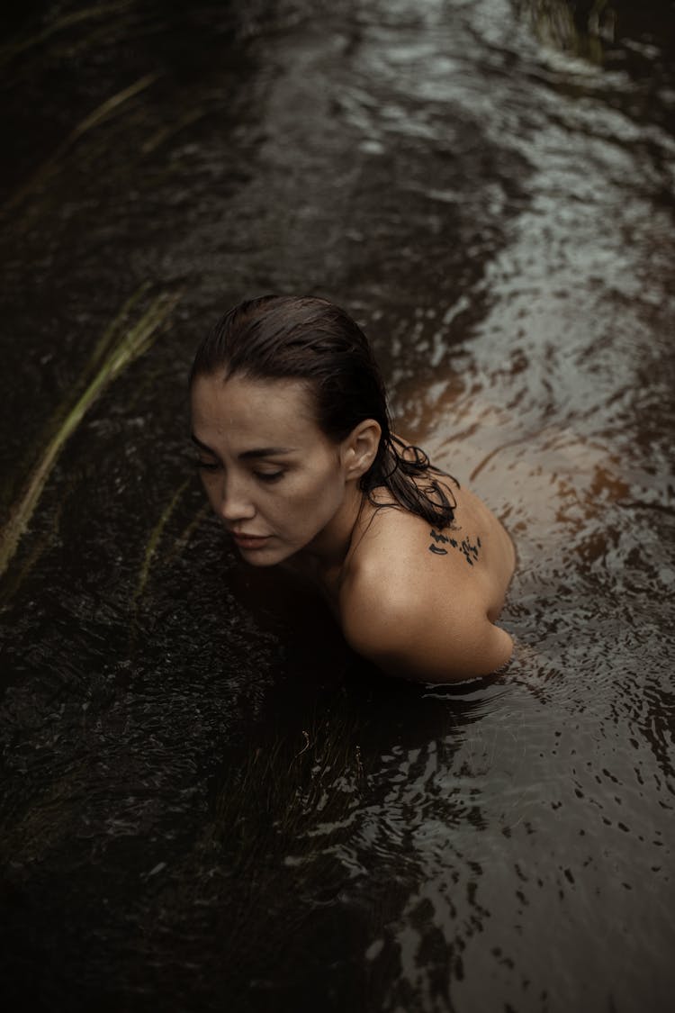 Topless Woman Swimming In Water