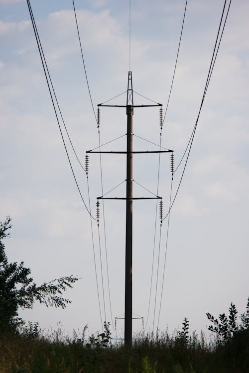 Low-Angle Shot of an Electric Post under the Cloudy Sky