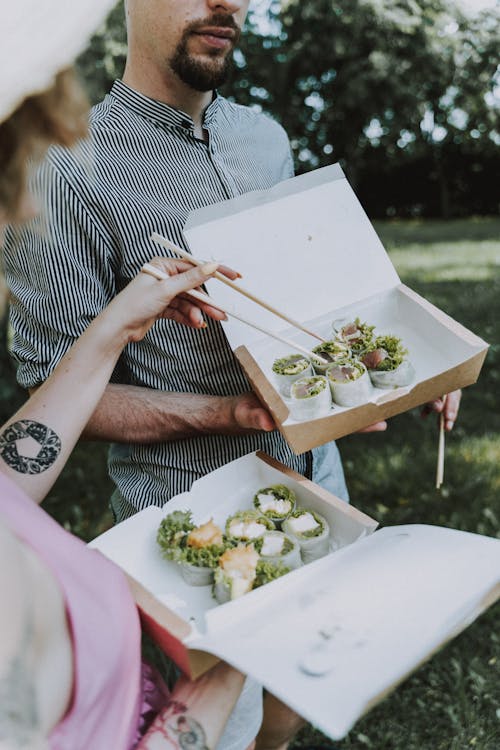 Two People Eating Sushi 