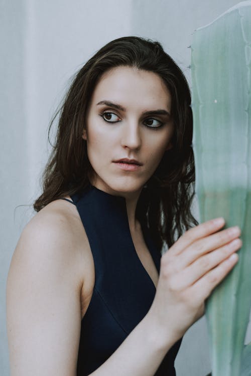 Woman in Black Tank Top Beside Agave Leaf