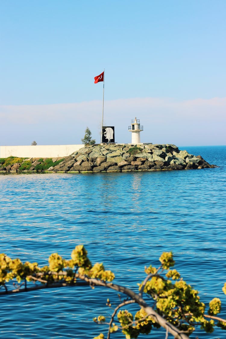 A Flagpole On A Seashore