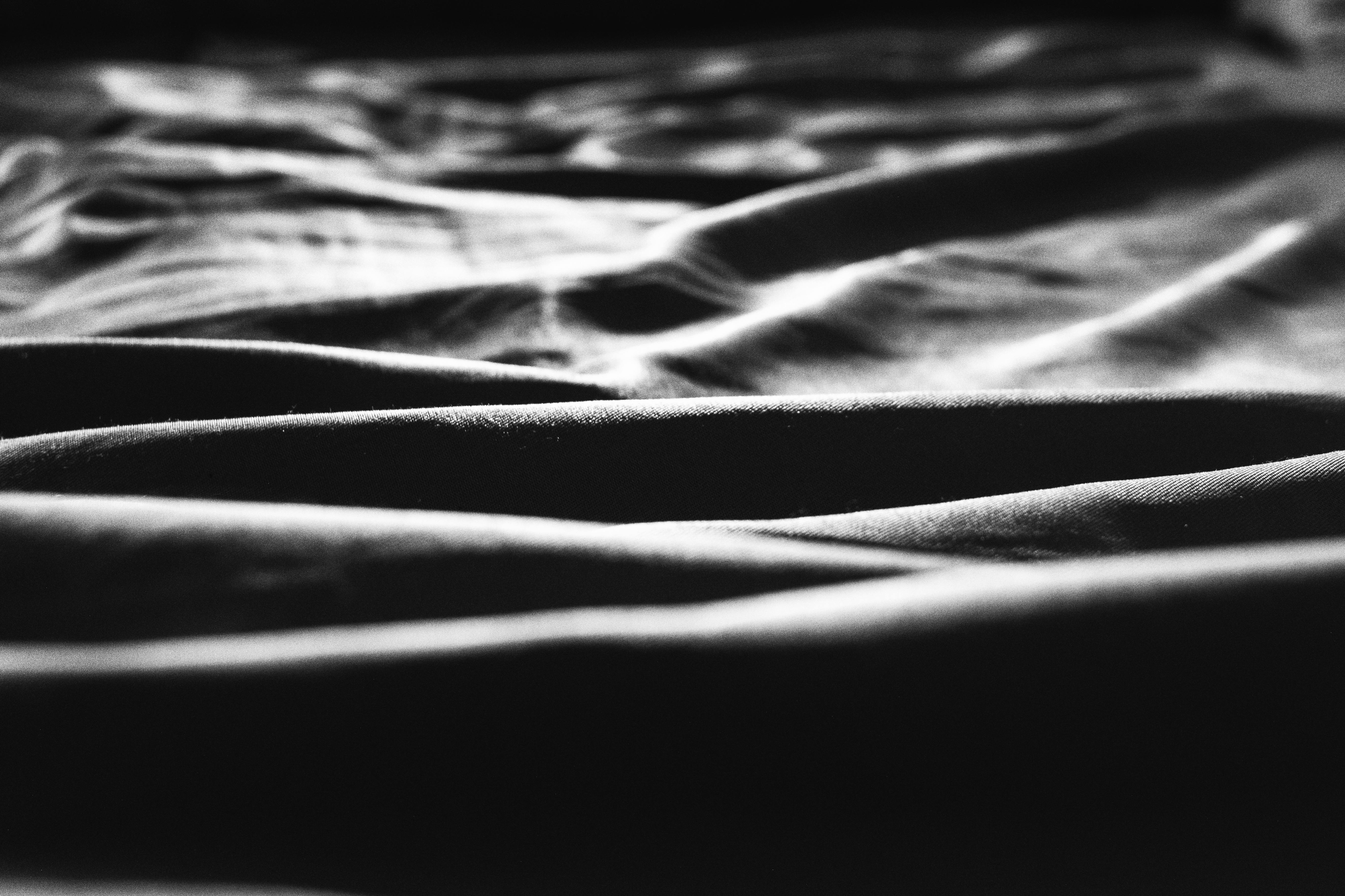 Abstract monochrome photo of draped fabric showcasing textures and light