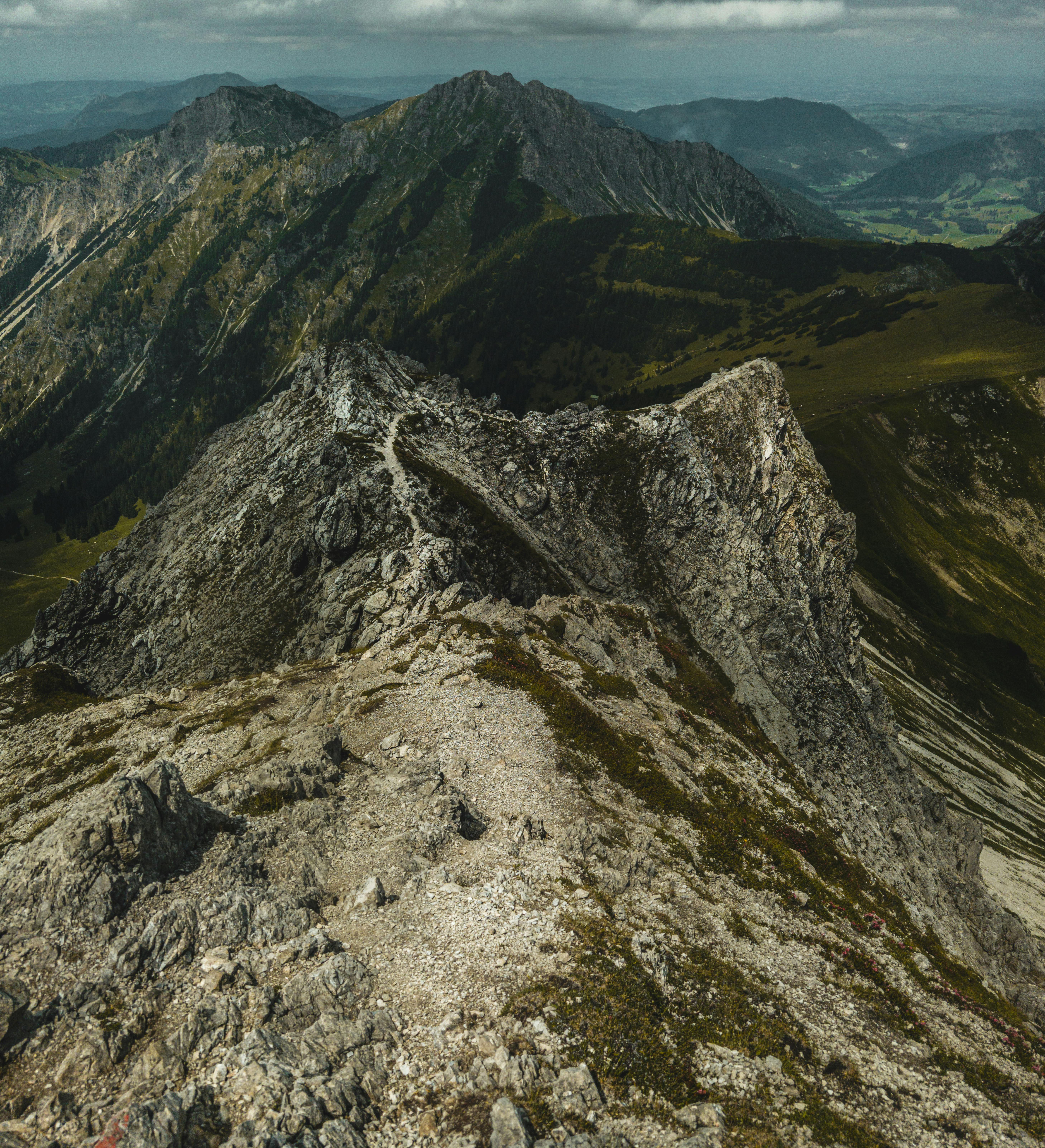 Explore the stunning rugged mountain landscapes under a blanket of clouds.