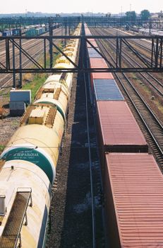 Aerial view of a cargo train on railway tracks during the day.
