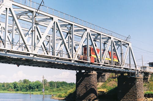 Free Red Wagon on Steel Bridge During Sunny Day Stock Photo