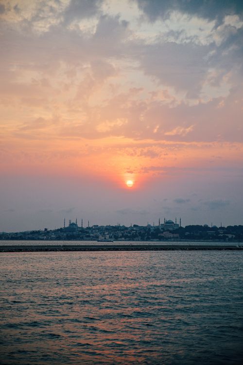 Free Beautiful sunset over the Bosphorus in Istanbul with city skyline and vibrant clouds. Stock Photo