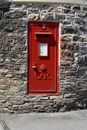 Red Telephone Booth on Brown Brick Wall