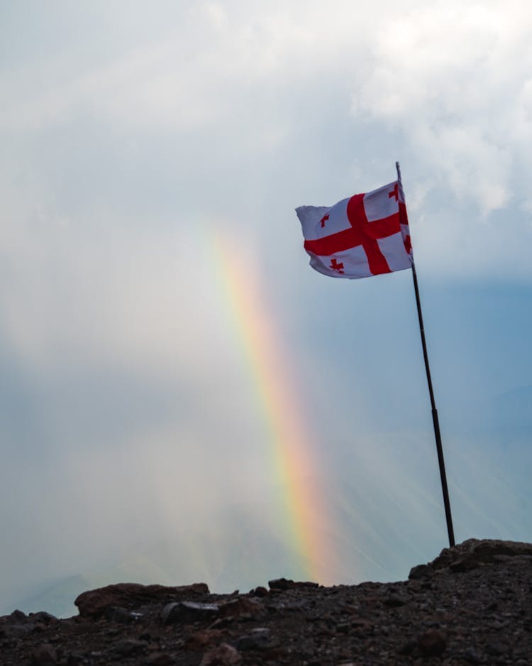 A Flag Of England On A Mountain Peak