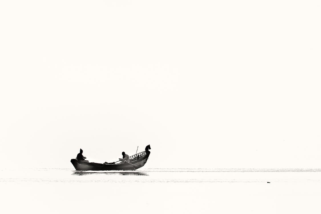 Two Person Riding Boat on Body of Water · Free Stock Photo