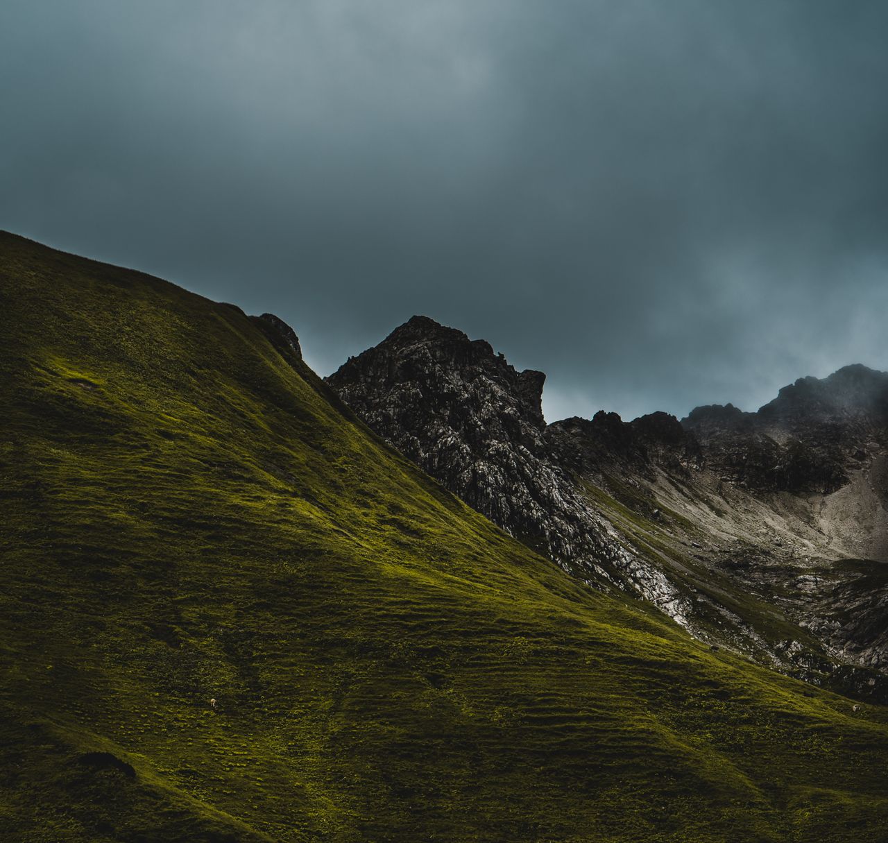 captivating mountain view with green slopes and dramatic skies perfect
