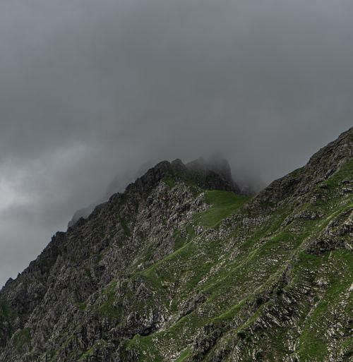 Free Dramatic mist-covered rocky mountain landscape with lush greenery. Stock Photo