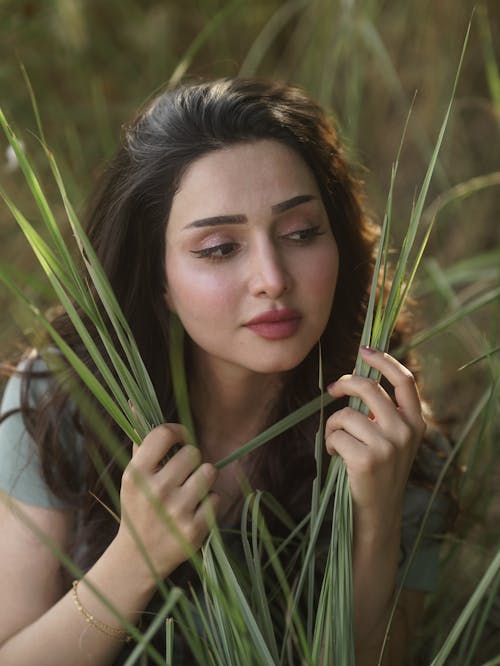 A Woman Holding a Green Grass