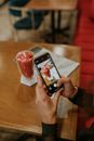 Close-Up Shot of a Person Taking a Photo of the Smoothie