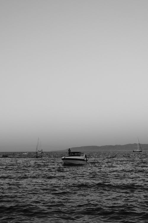 Grayscale Photography of Boat on Water