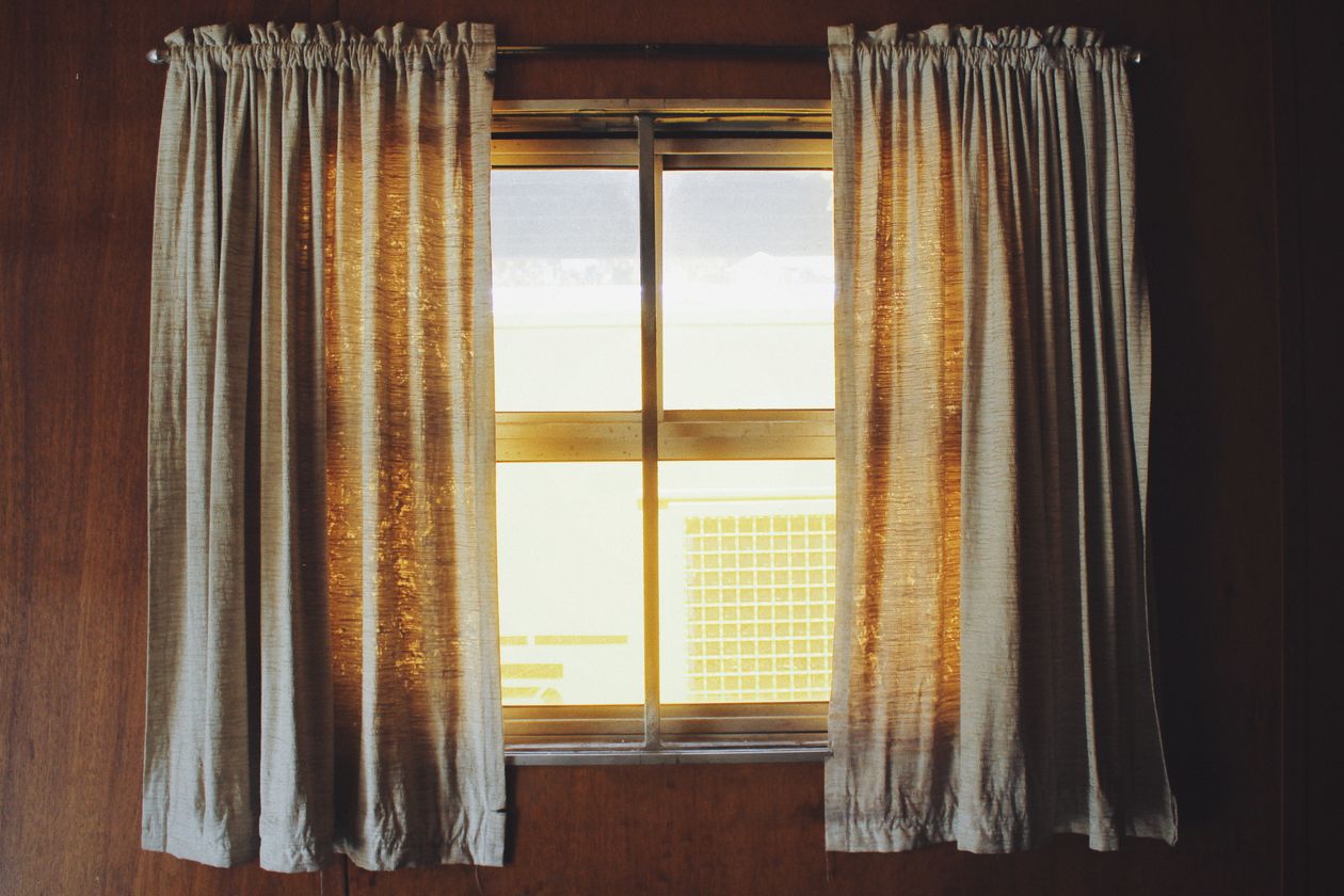 Golden floor-length curtains glowing in warm light