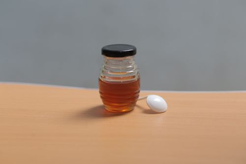 Free Close-up of a jar of honey with spoon on a wooden table, indoors. Stock Photo
