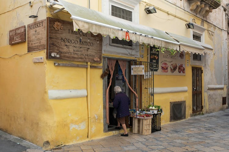 A Woman Entering The Yellow Building