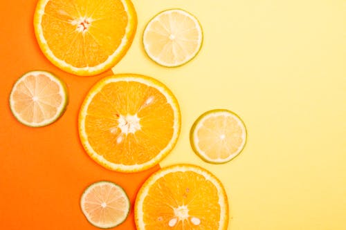 Orange Slices on Yellow Background