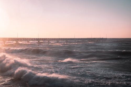 A Waves Crashing on Sea Under the Twilight Sky