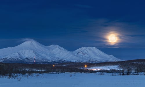 Snow Covered Mountain Under the Night Sky