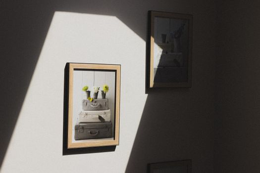 Sunlit wall with framed minimalist art in a sleek indoor setting