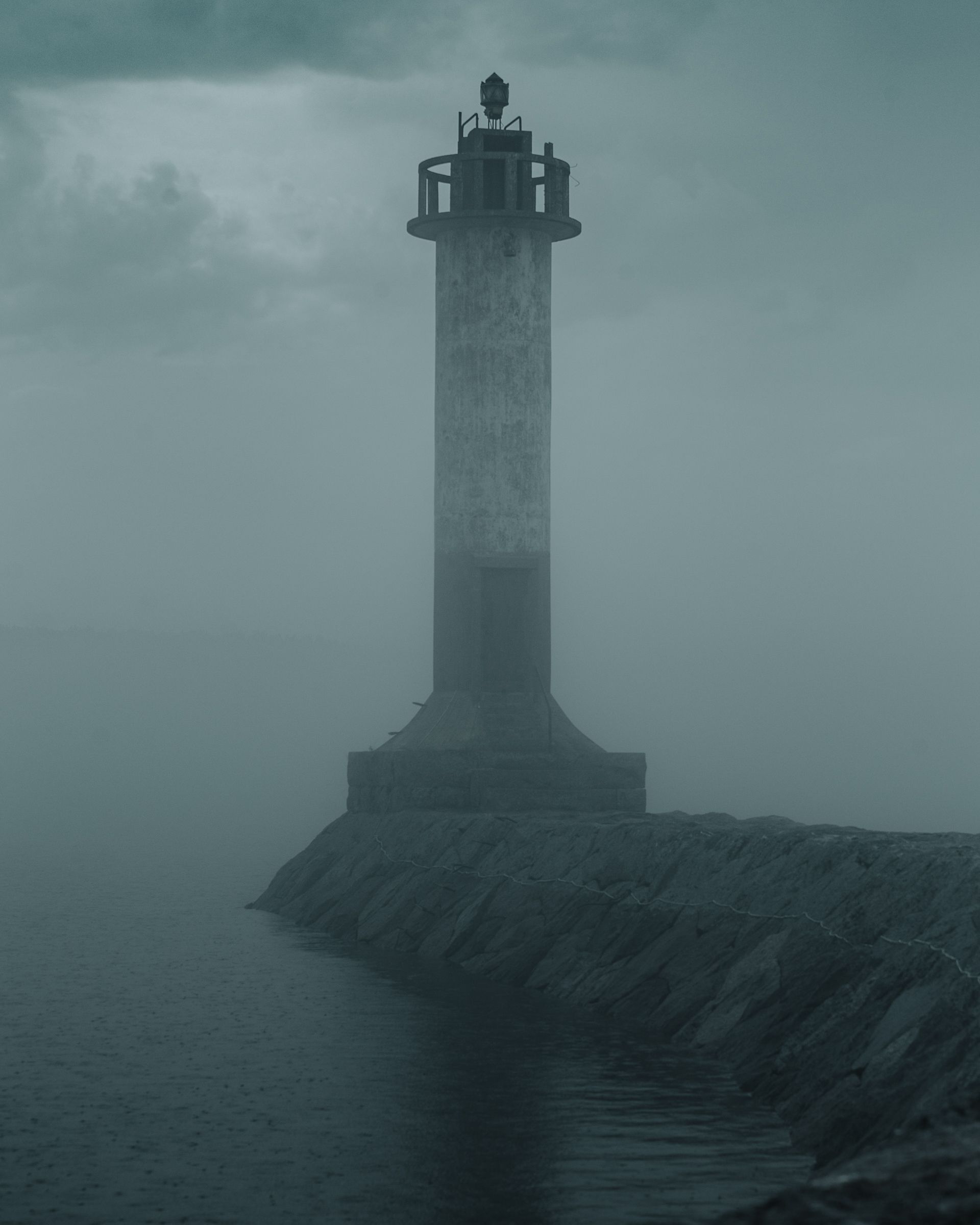 Eerie lighthouse surrounded by fog