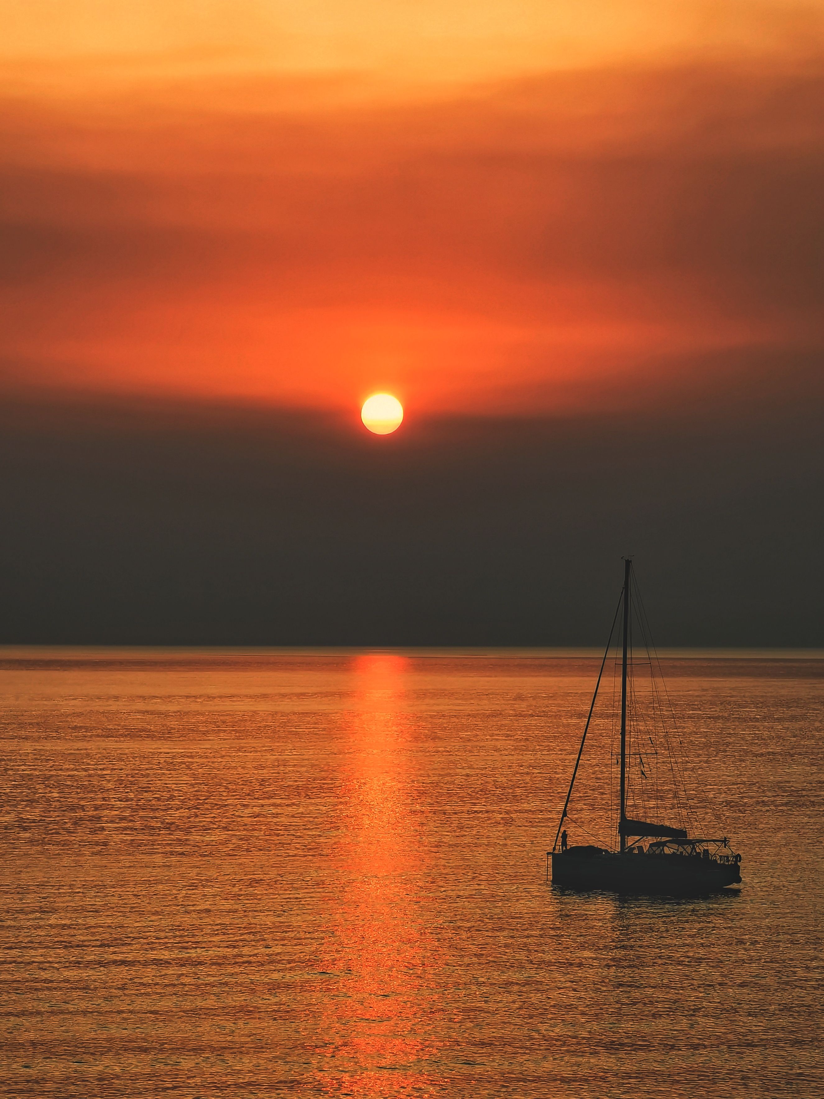 Silhouette of Boat on Sea During Sunset · Free Stock Photo