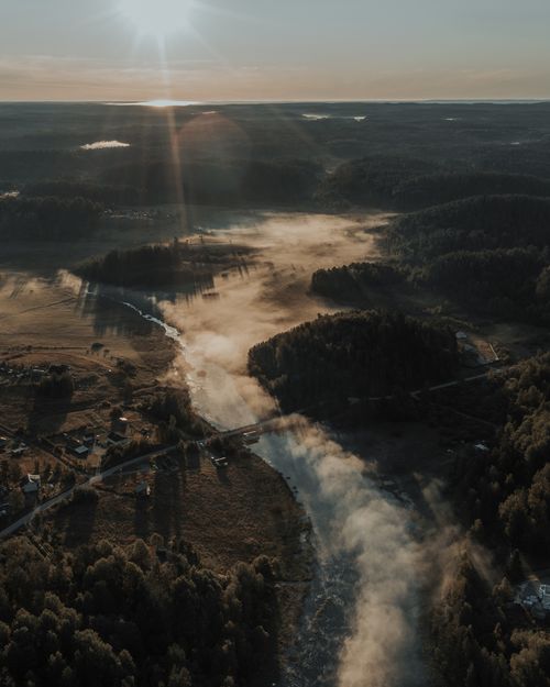Free Aerial view of a fog-covered river landscape at sunrise in the Russian countryside. Stock Photo