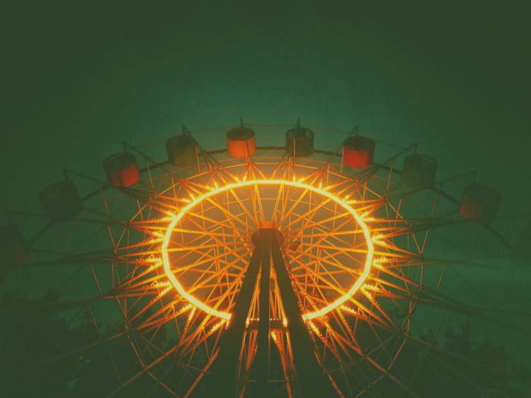 Low Angle View Of Lit Up Ferris Wheel