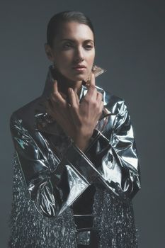 Sophisticated studio portrait of a woman in metallic fashion wear.