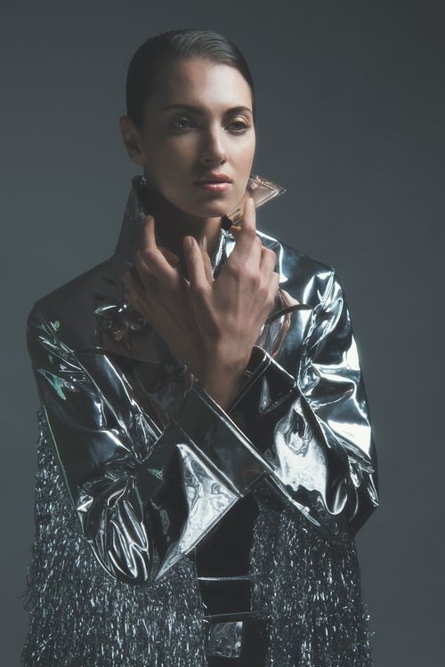 Free Sophisticated studio portrait of a woman in metallic fashion wear. Stock Photo