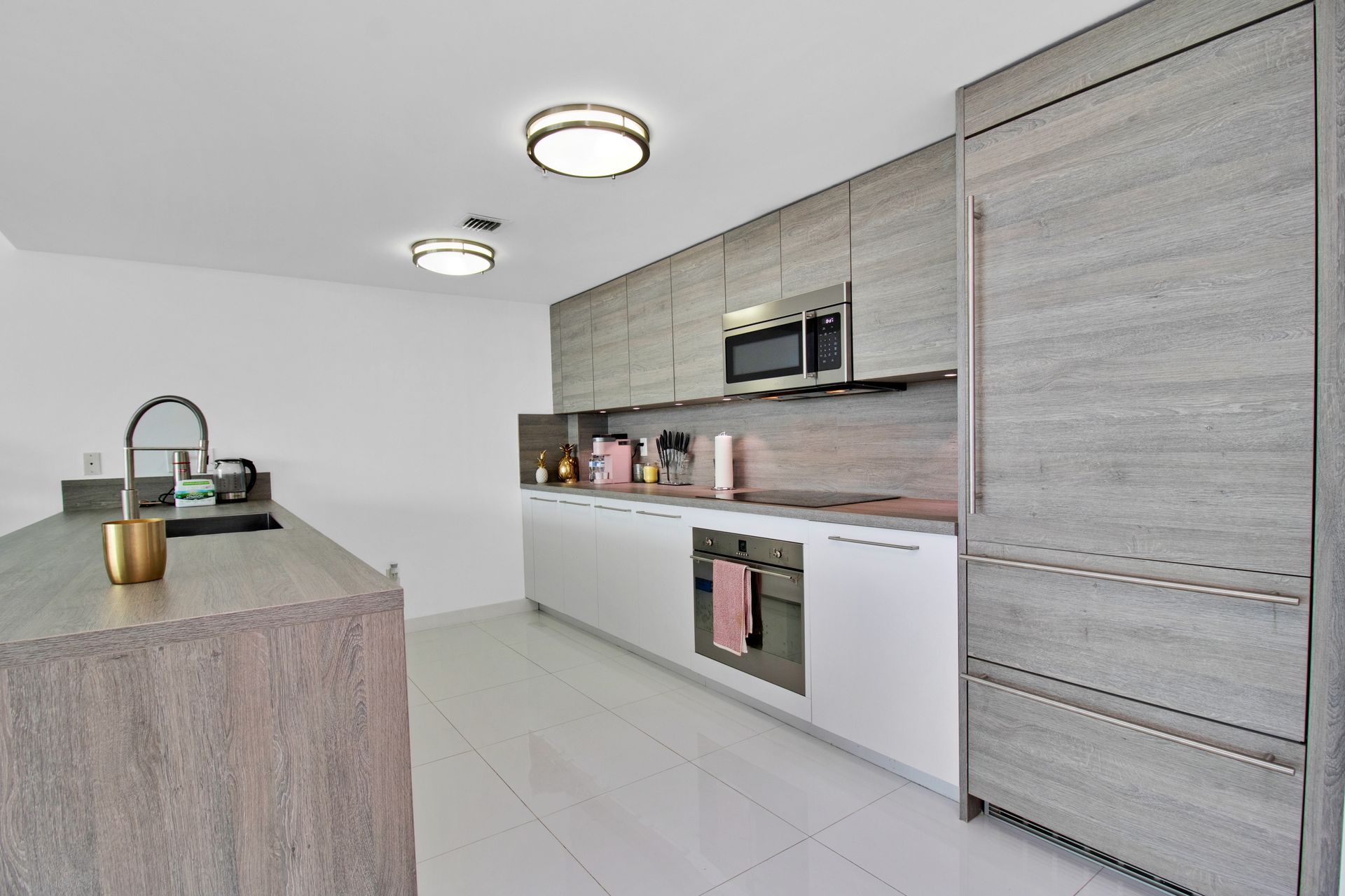 Contemporary kitchen featuring white cabinets and wooden accents for a stylish look.