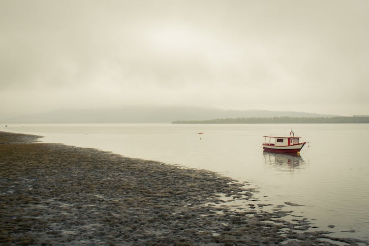 Red Boat Anchored On Seashore