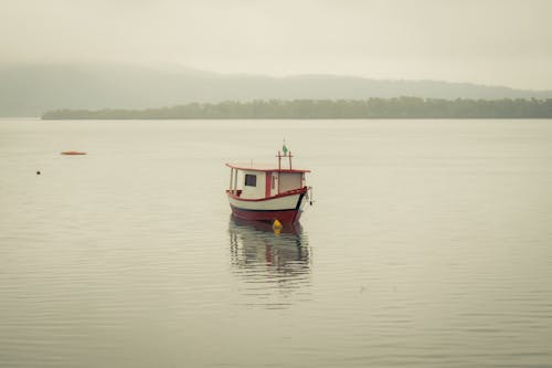 A Red and White Boat on the Water