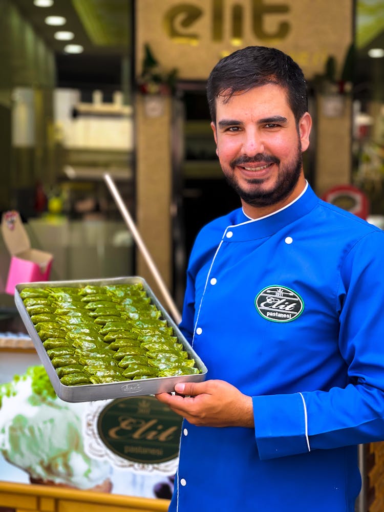 Man In Blue Sweater Holding Tray With Food 