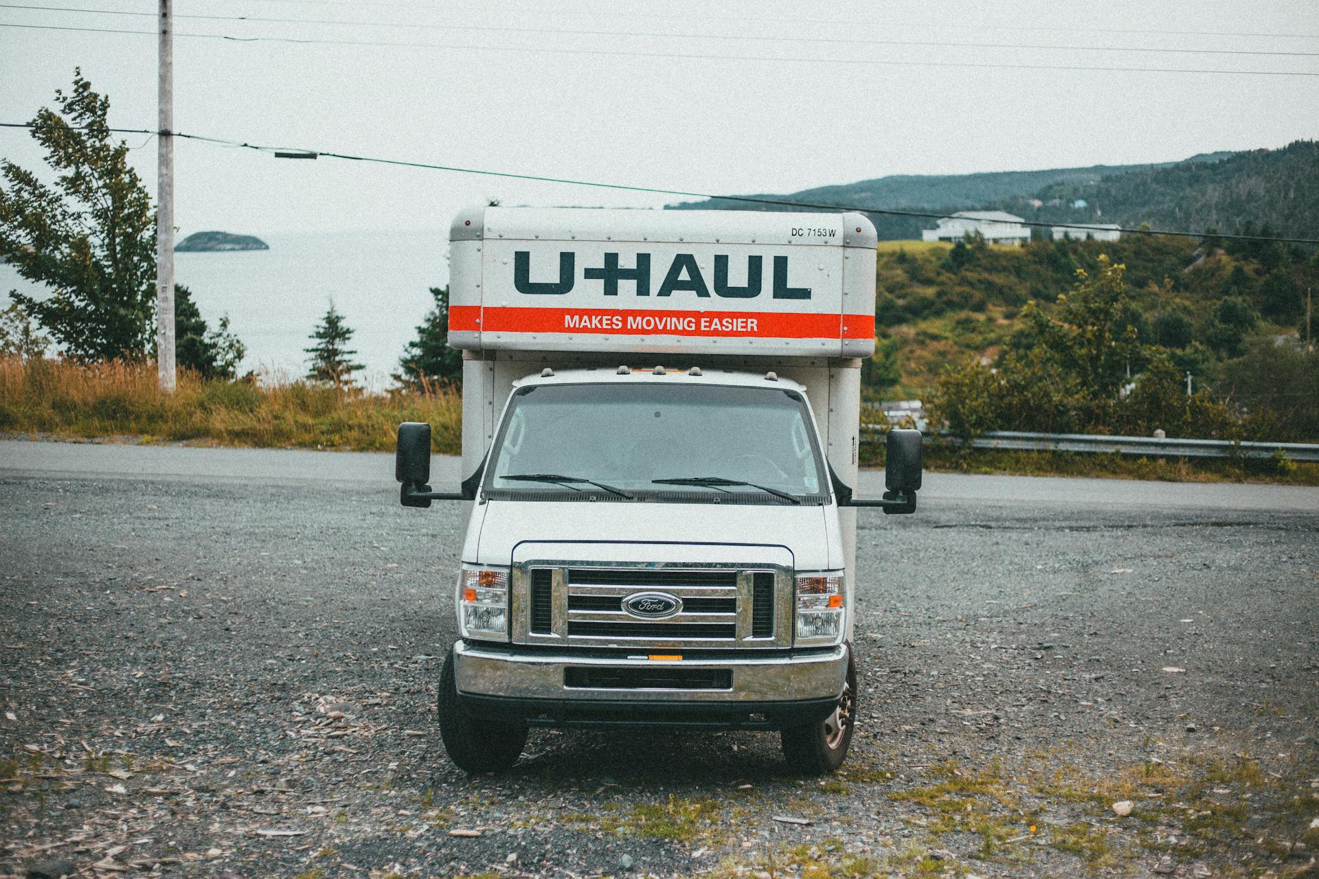 A U-Haul truck parked on a dirt road with a scenic outdoor backdrop, ideal for moving service promotions.