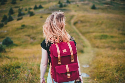 Woman Wearing Backpack Standing in Front Building · Free Stock Photo