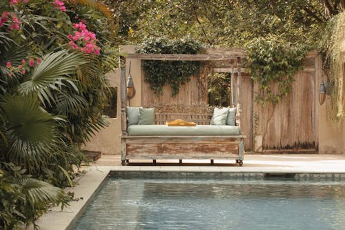 Brown Wooden Bed Near Swimming Pool