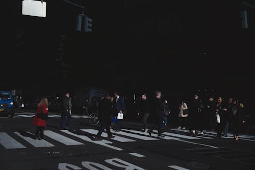 Photo of People Walking on Pedestrian Crossing