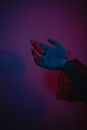 Persons Left Hand on Pink Textile