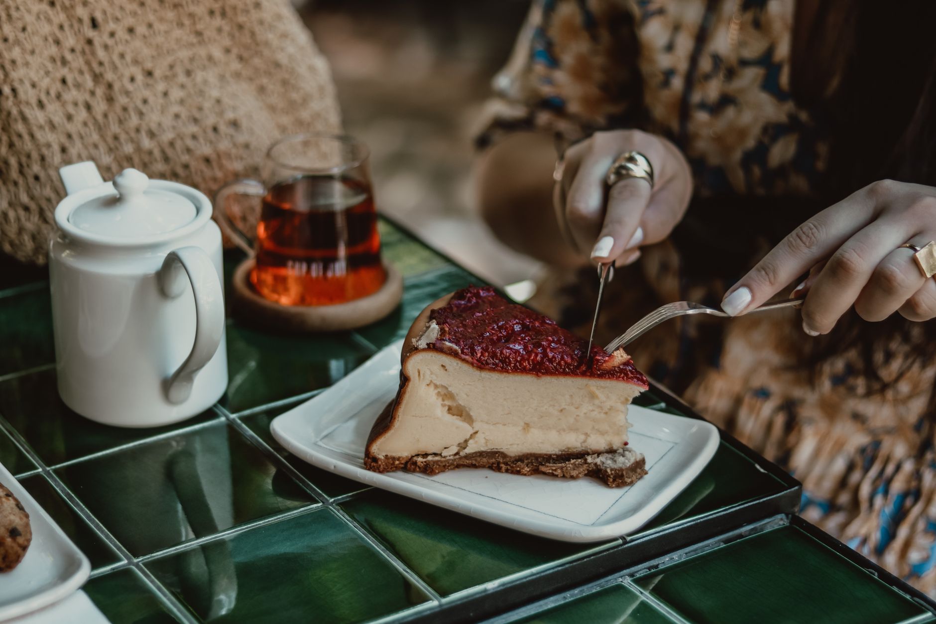 A whole burnt Basque cheesecake on a rustic wooden table, freshly baked and ready to slice