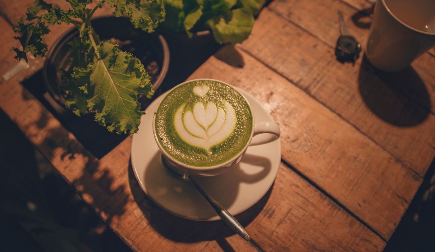 A matcha latte on a wooden table