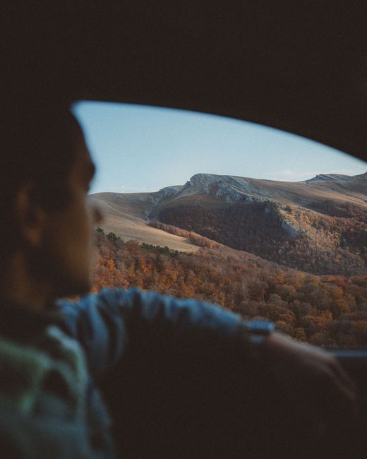Beautiful mountain view captured from inside a car, highlighting nature's tranquility.
