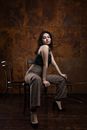 Woman in Gray Tank Top and Gray Pants Sitting on Chair