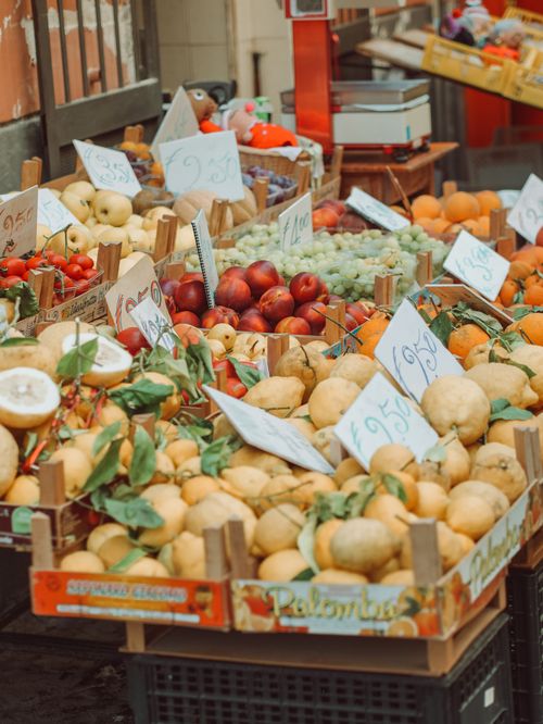 Free Colorful display of fresh fruits at a market in Sorrento, Italy, featuring citrus and other seasonal produce. Stock Photo