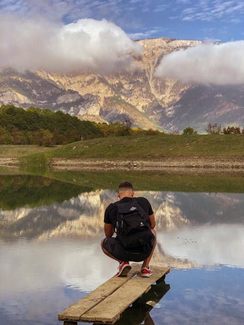 A Man Sitting on the Wood Plank